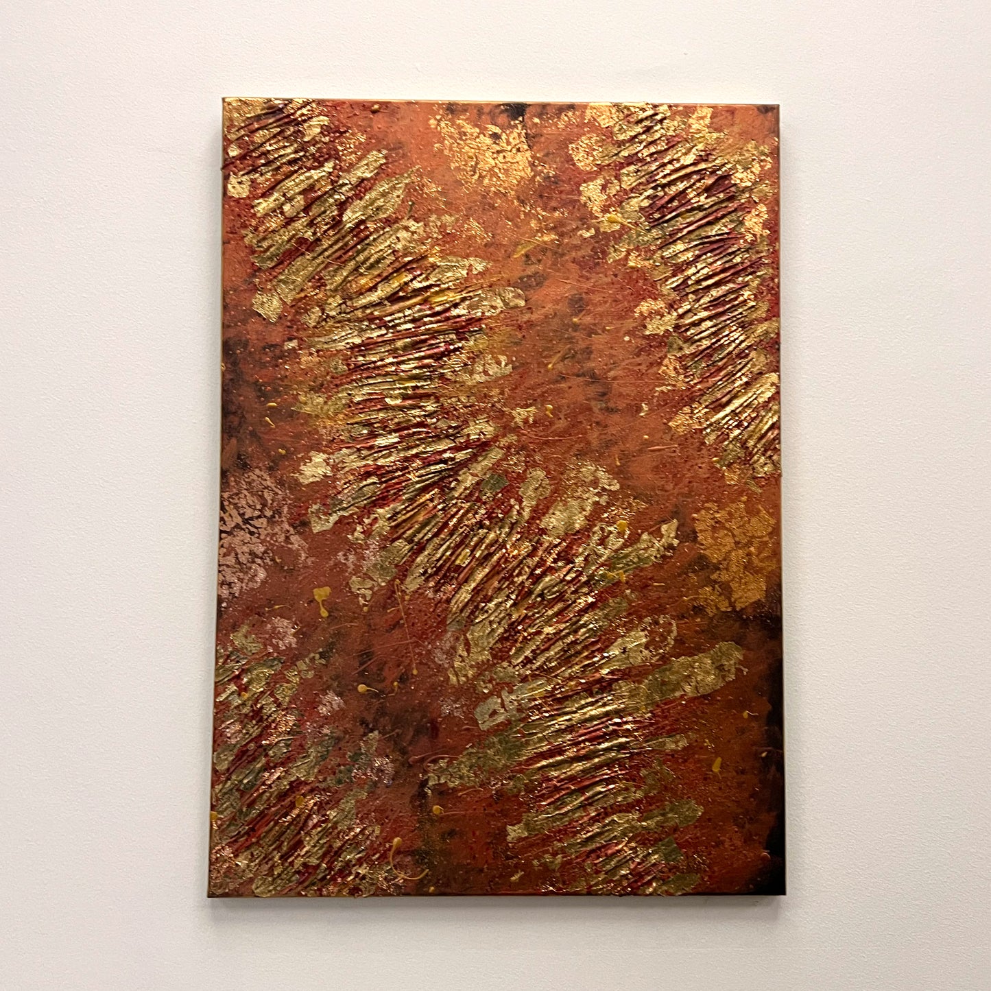 Highly textured abstract painting featuring shimmering gold leaf patterns across a warm red, brown, and copper-toned backdrop, available at HEADS Art Gallery.