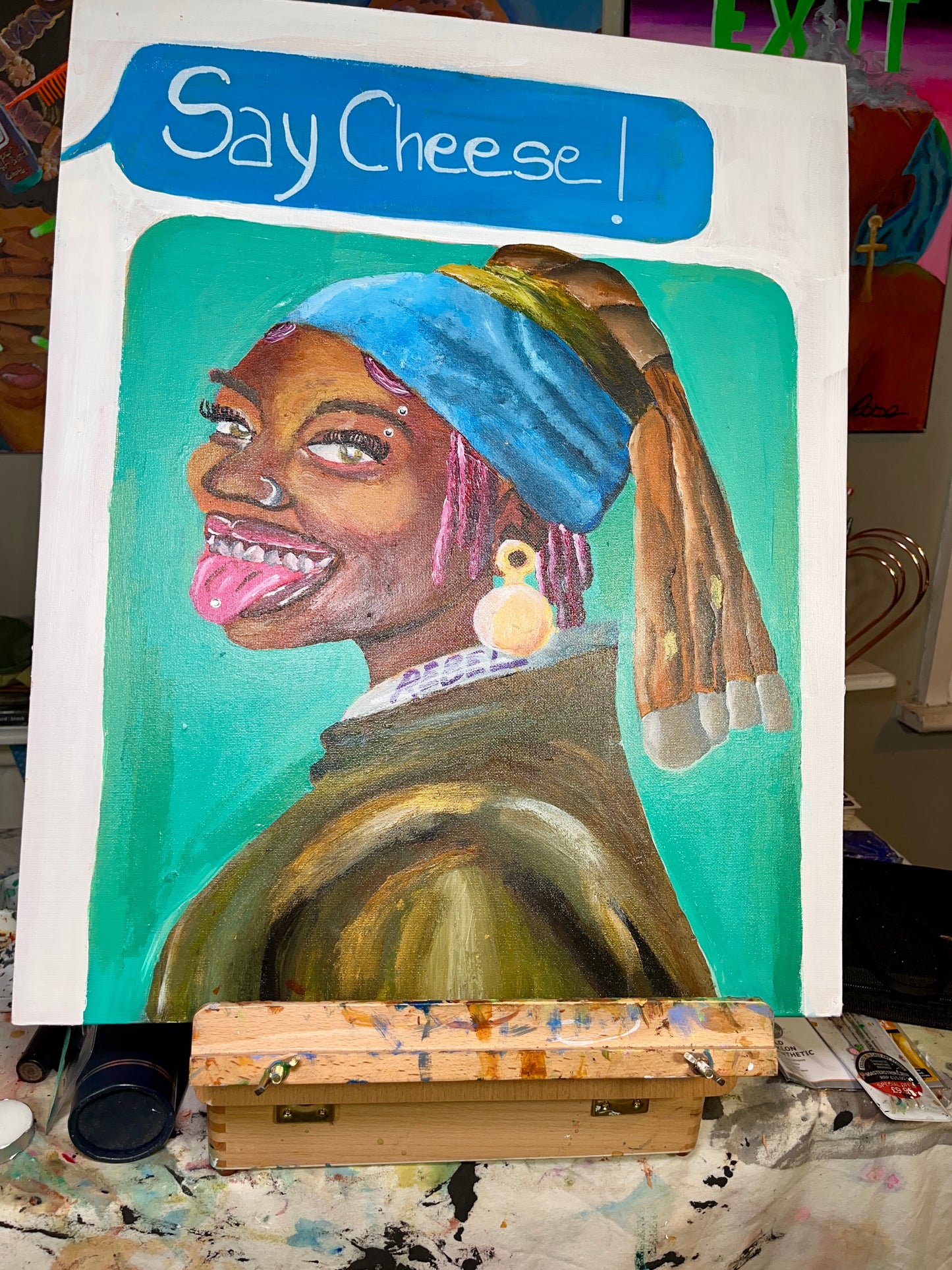 Painting of a person with a blue headscarf and pink lipstick, with 'Say Cheese!' text above.
