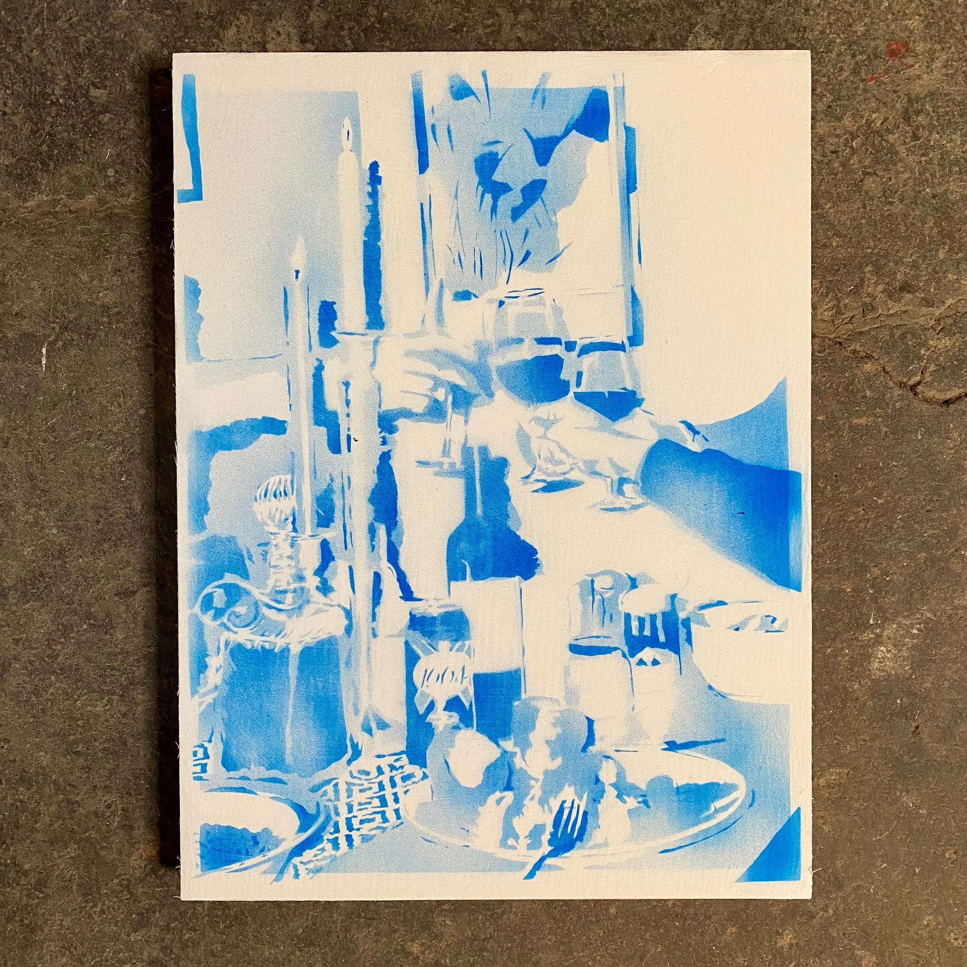 Abstract blue and white artwork on a textured brown surface