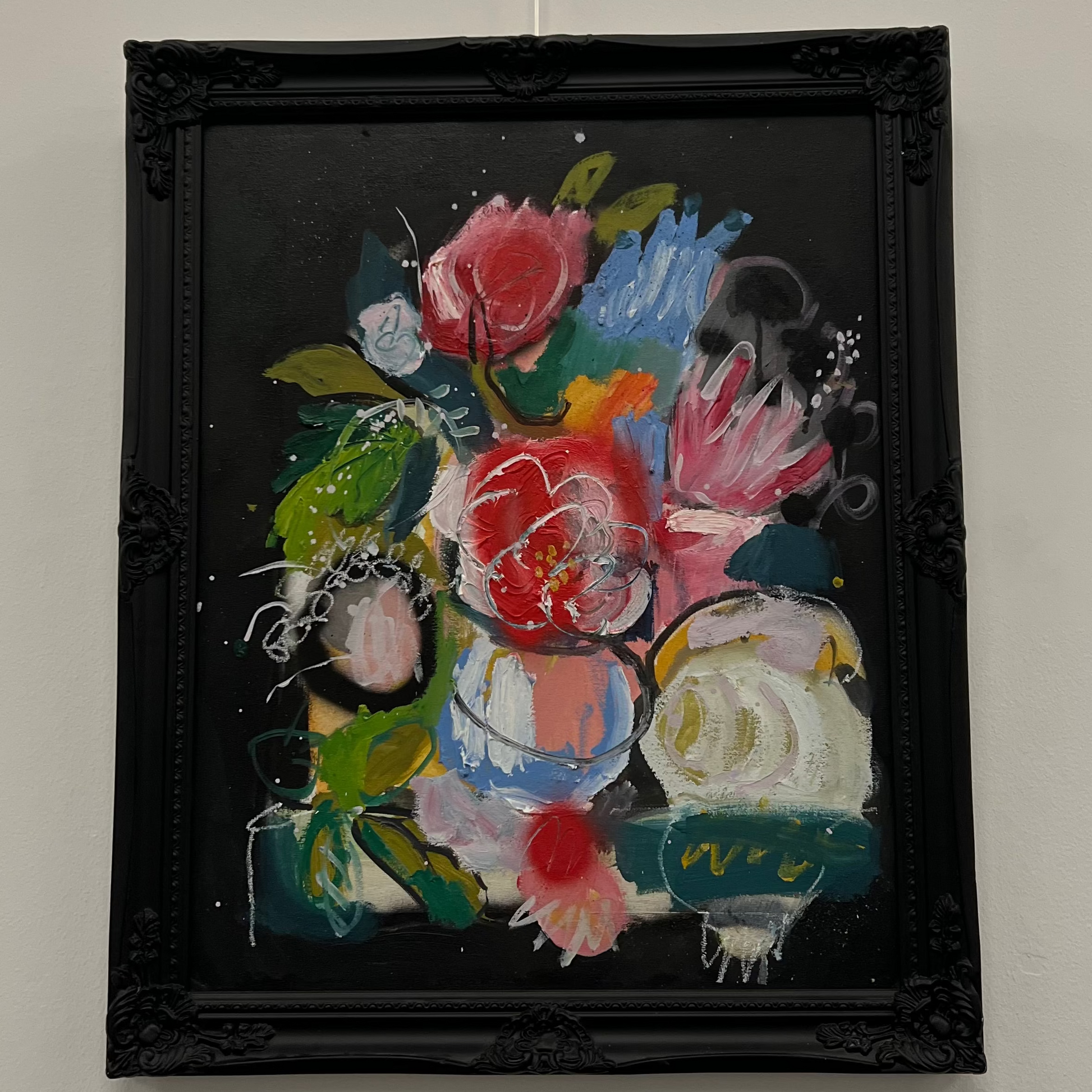 Contemporary floral still life painting of red roses and green foliage in a vase, set against a solid black background and housed in an ornate black frame, available at HEADS Art Gallery.