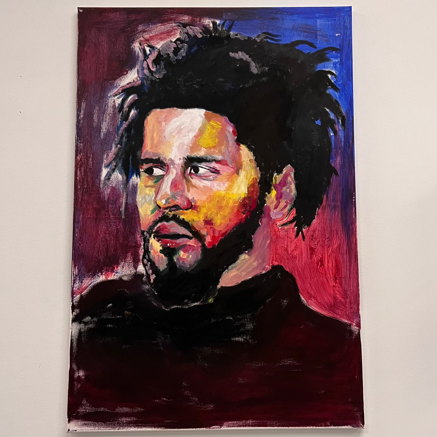 Painting of rapper J. Cole in profile against a deep red and blue background, available at HEADS Art Gallery.