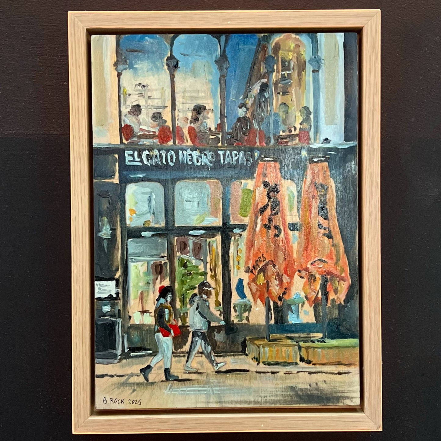 Lively evening painting of the El Gato Negro Tapas restaurant on King Street, Manchester, featuring figures passing by, available at HEADS Art Gallery.