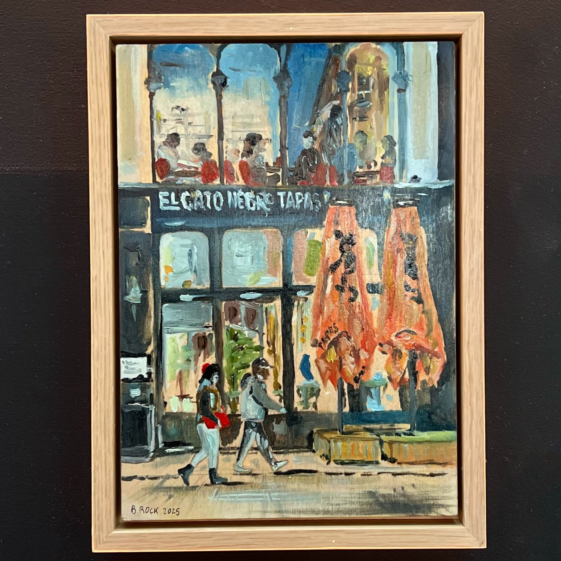 Lively evening painting of the El Gato Negro Tapas restaurant on King Street, Manchester, featuring figures passing by, available at HEADS Art Gallery.