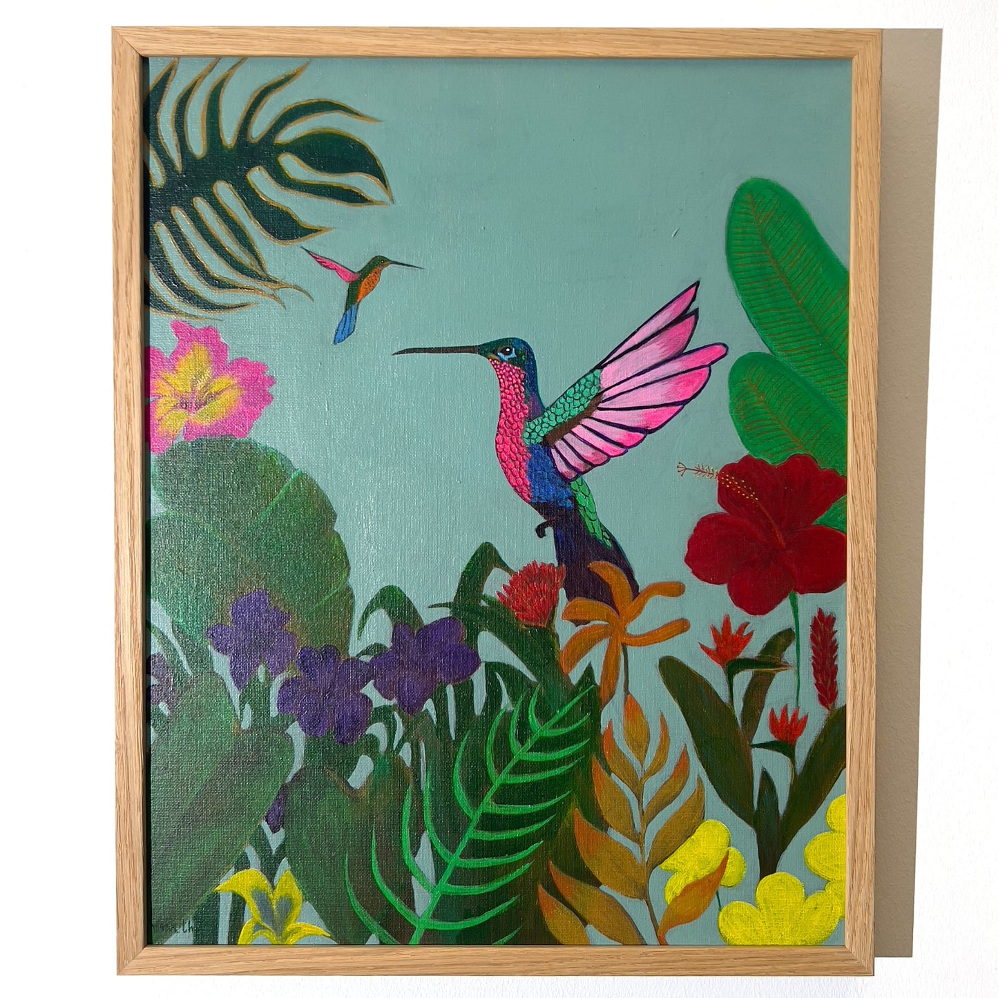 Bright and colorful painting of a vibrant hummingbird in mid-flight surrounded by lush tropical jungle foliage and red hibiscus flowers, available at HEADS Art Gallery.