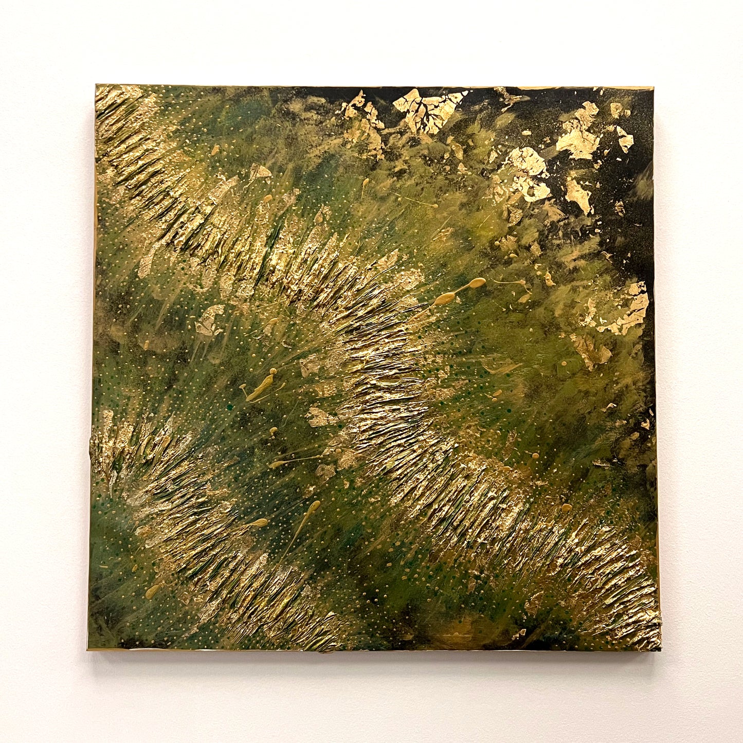 Textured abstract piece with flowing gold leaf accents and paint splatters across a deep green, mossy, and olive-colored background, available at HEADS Art Gallery.
