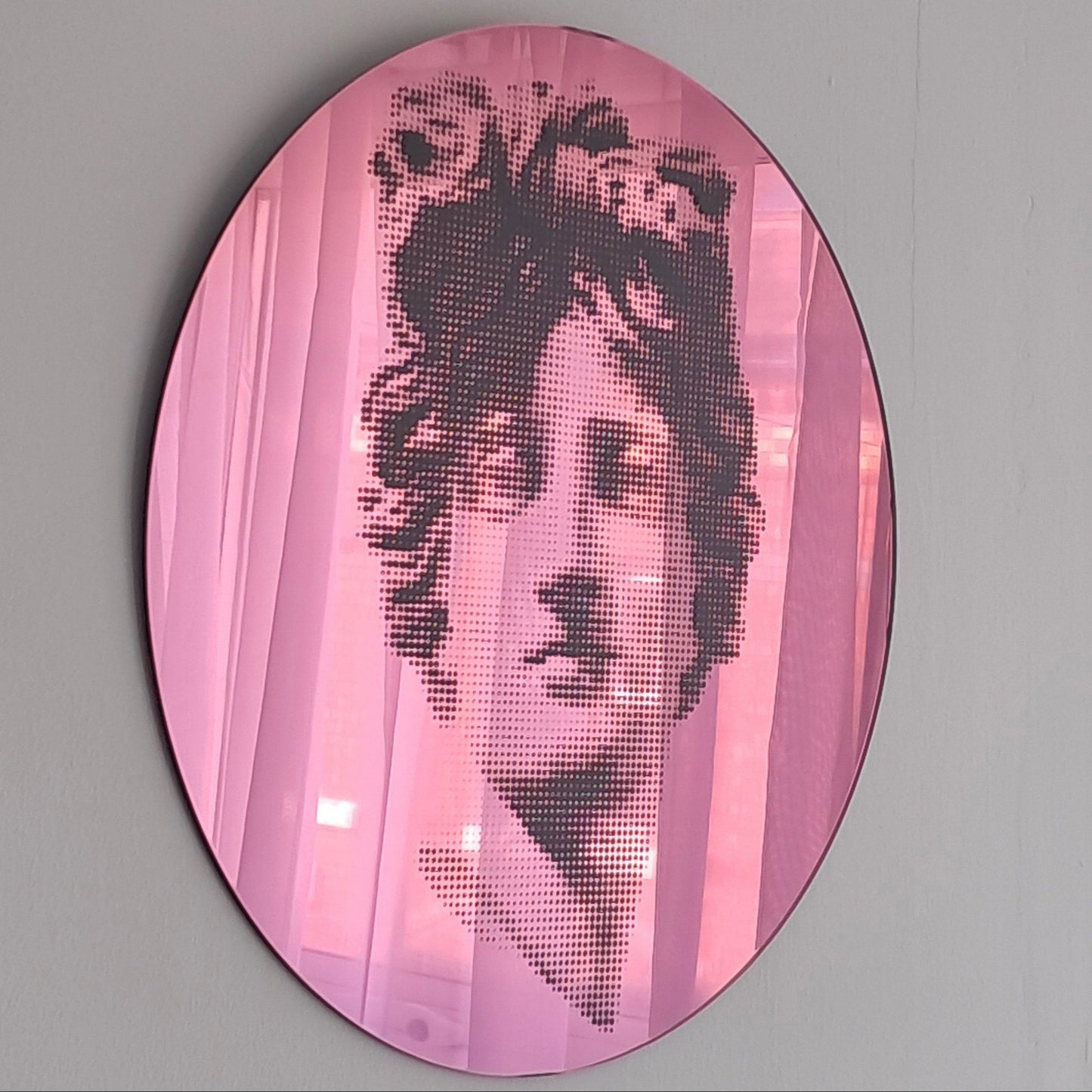 Oval pink-tinted mirror featuring a halftone-dotted classical female portrait modern interior decor (Memento Mori), available at HEADS Art Gallery.