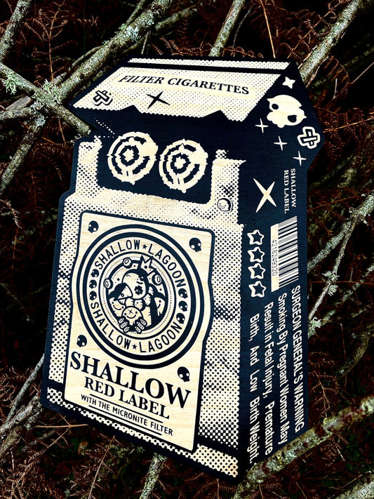 Bold graphic art piece designed as a "Shallow Red Label" cigarette pack with black and white halftone patterns, available at HEADS Art Gallery.