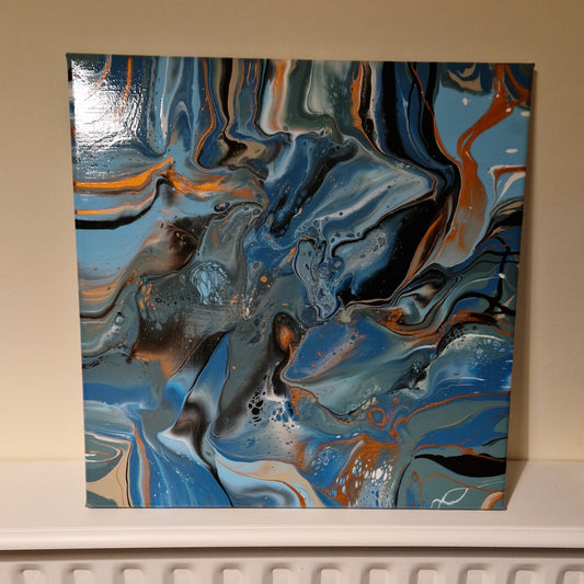 Abstract painting with swirling blue, orange, and black colors on a beige wall.