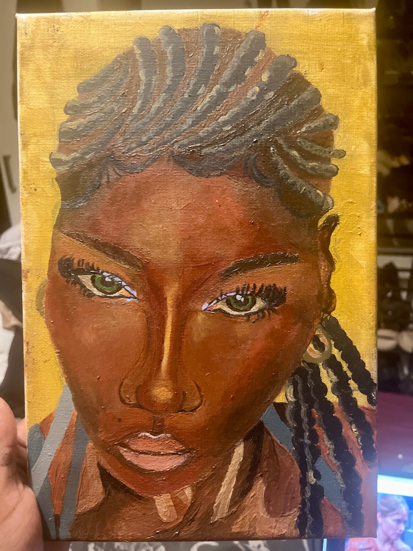 Painting of a woman's face with braided hair on a gold background